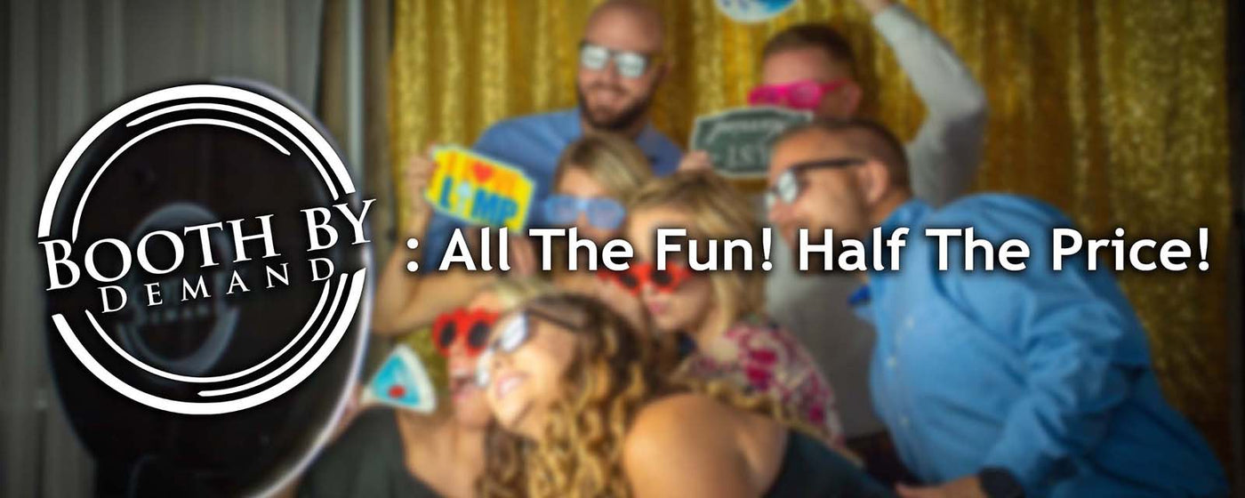 Party guests posing in front of photo booth