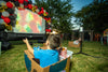 Kids Watching a Movie on an Inflatable Projector in Cardboard Box Cars