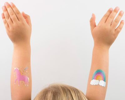 unicorn & rainbow temporary tattoos on little girl